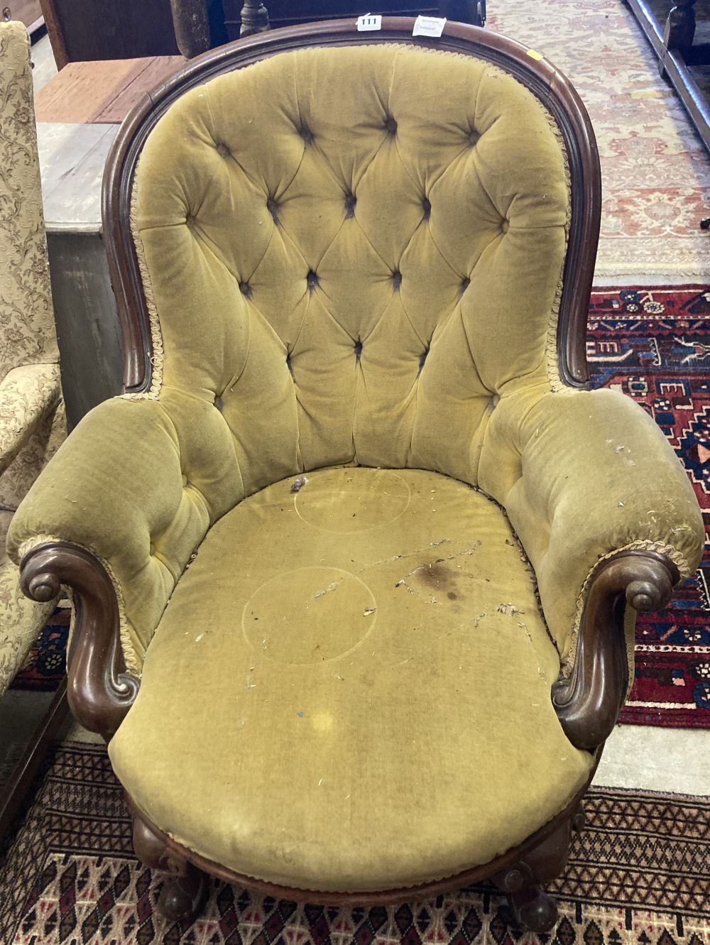 A Victorian mahogany framed button spoonback armchair